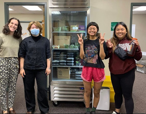 Four campus cupboard workers smiling.